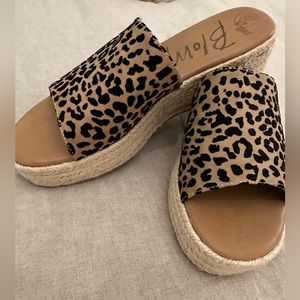 Slip on platform sandals, never worn. Brown with black animal print.